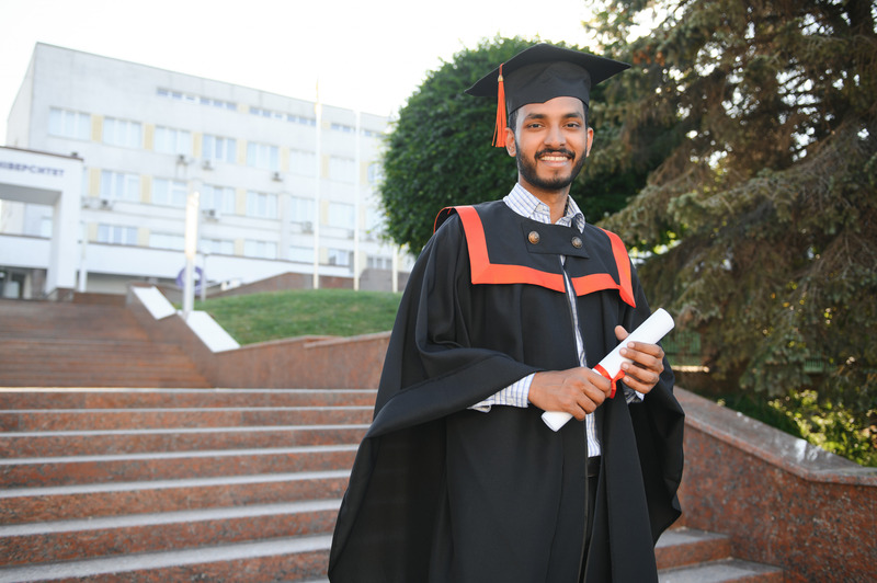 Graduate celebrating an online degree from Unistation